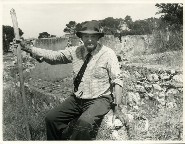 Lucius Manning sitting on wall at the ruins of Davilak House