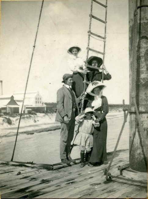 Lucius Manning with Victor's family on the ladder.