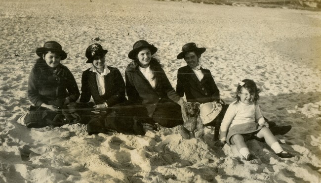 Olive Manning and children on the beach.