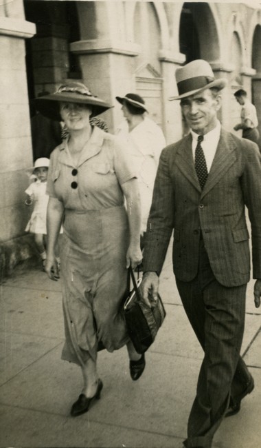 Couple walking in street in 1920s. 